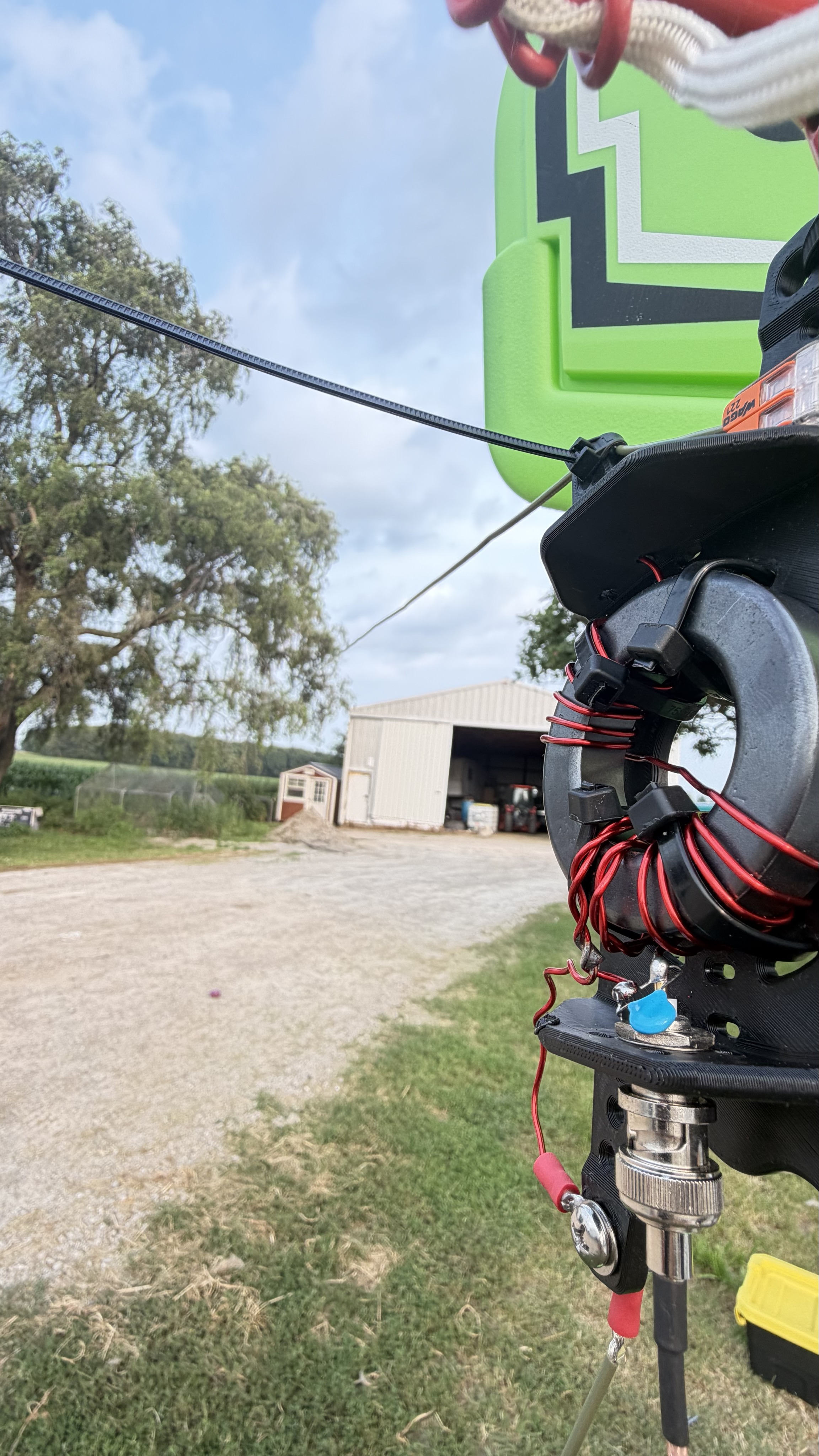Close-up of the 49:1 end-fed half-wave transformer mounted near the basketball hoop support.