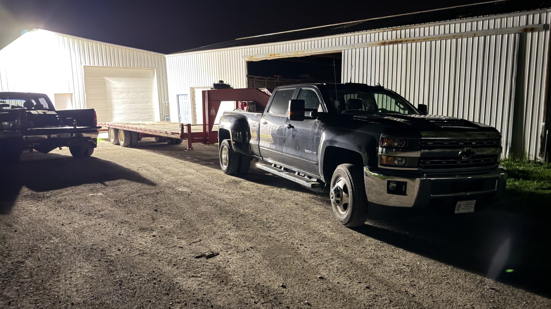 The second pickup and 30-foot gooseneck trailer staged for the trip.