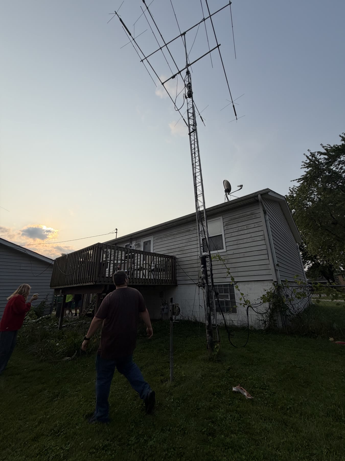 The 50-foot crank-up tower standing beside the house before work began.