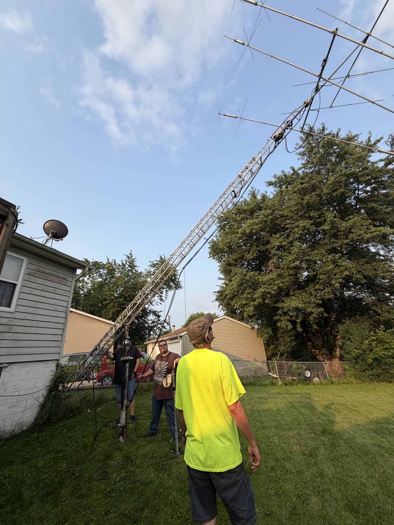 The crew carefully lowering the tower with its tilt-over mechanism.