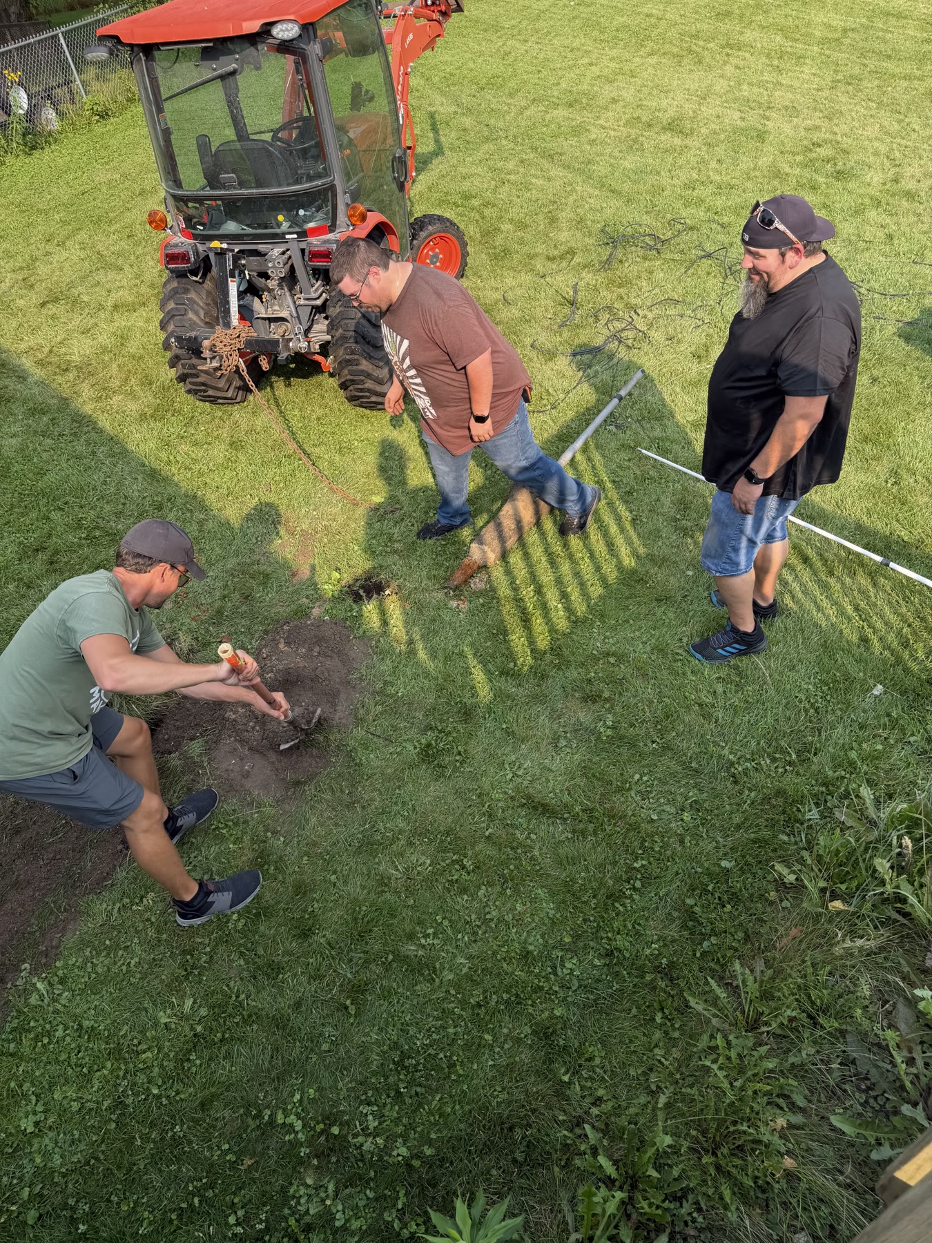 The crew finishing the second hole after removing the winch pole and its concrete footing.