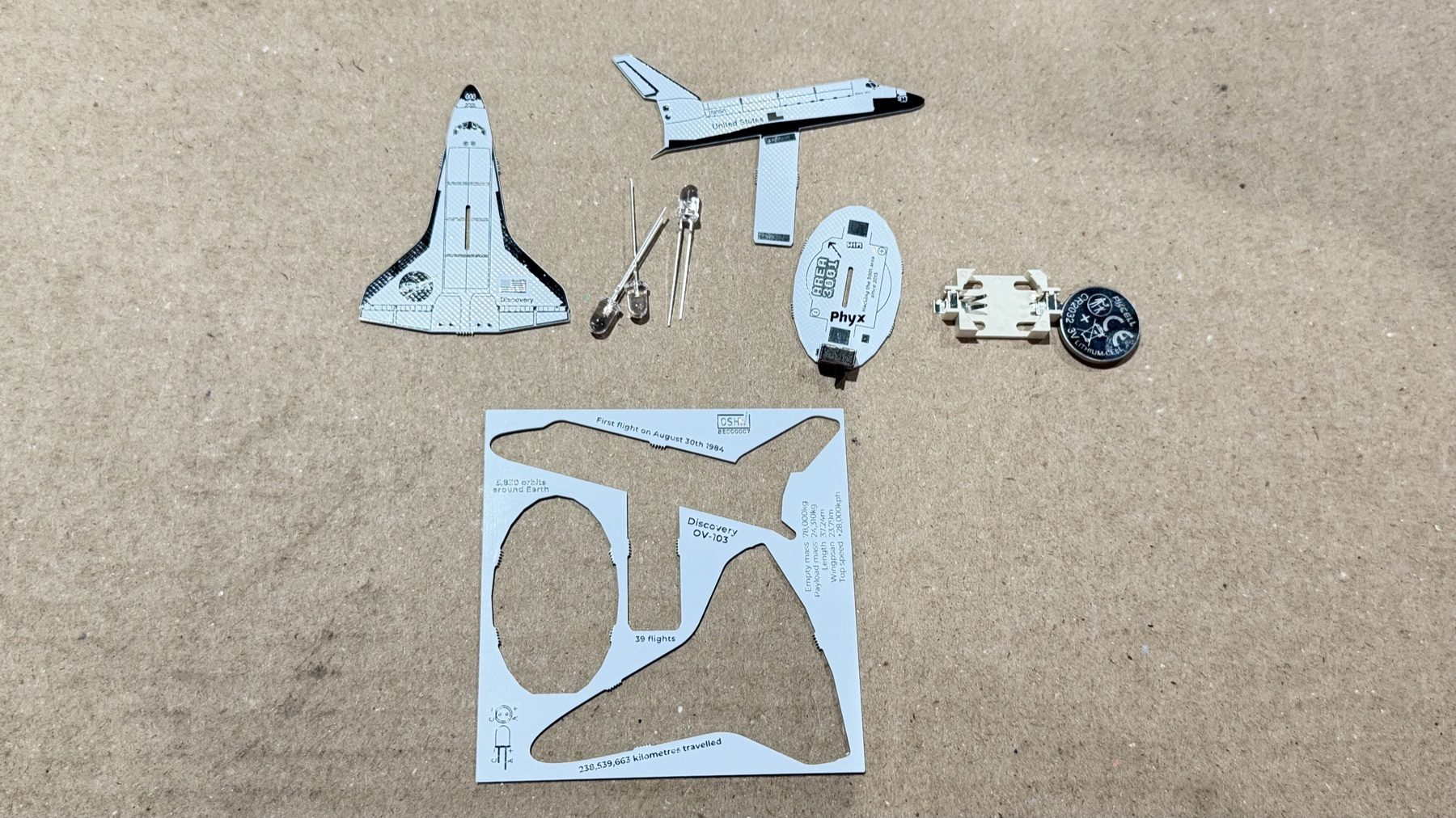 The shuttle circuit boards, electronic components, and hardware laid out for assembly.