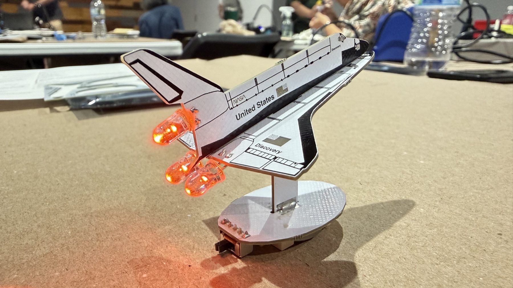 The completed shuttle with its red and orange engine LEDs illuminated.